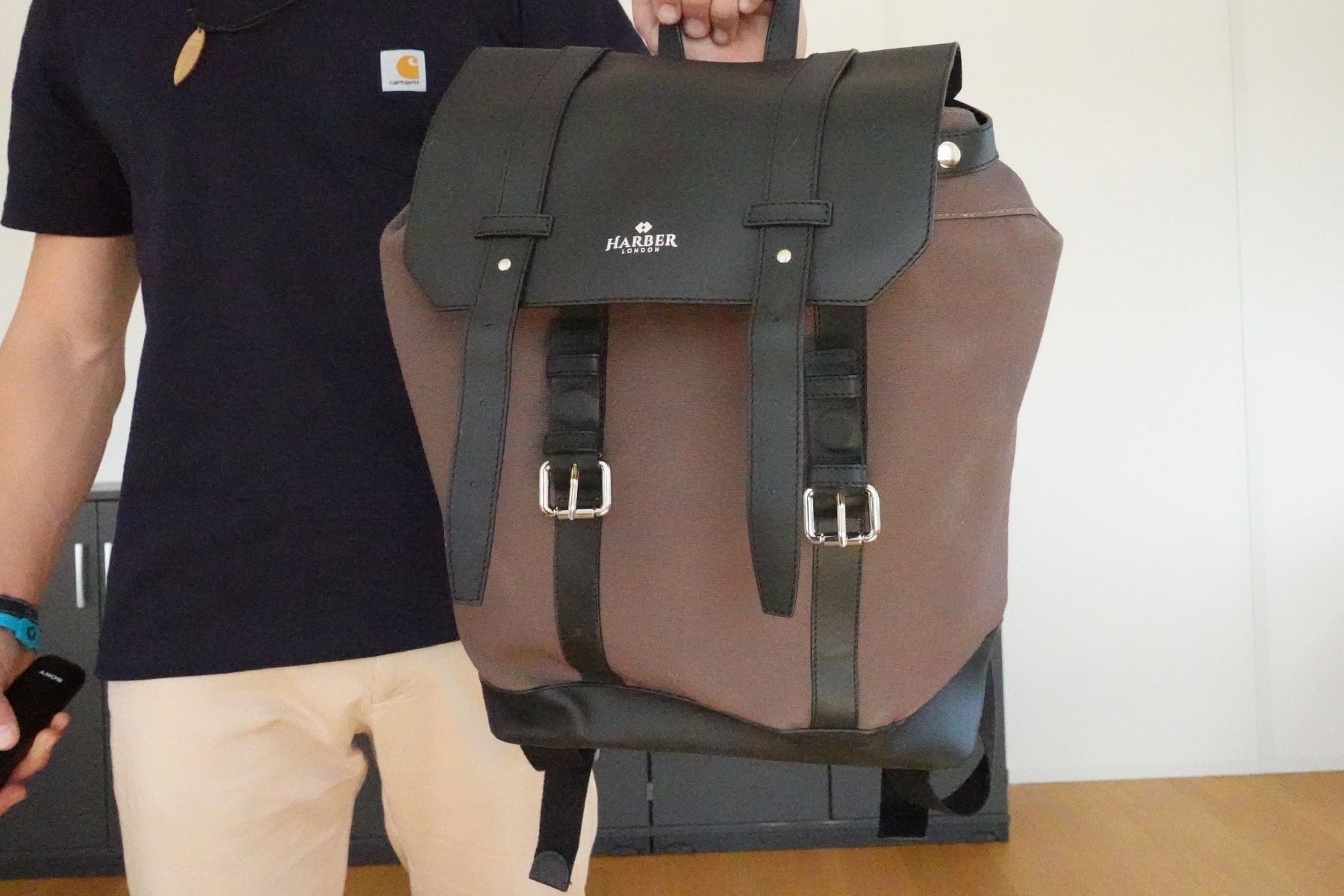 harber-london-classic-rucksack-held-on-one-hand-front-view