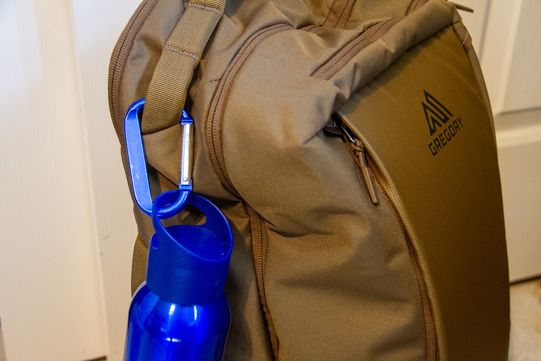 gregory-border-traveler-30-water-bottle-attached-with-a-carabiner-on-top-strap